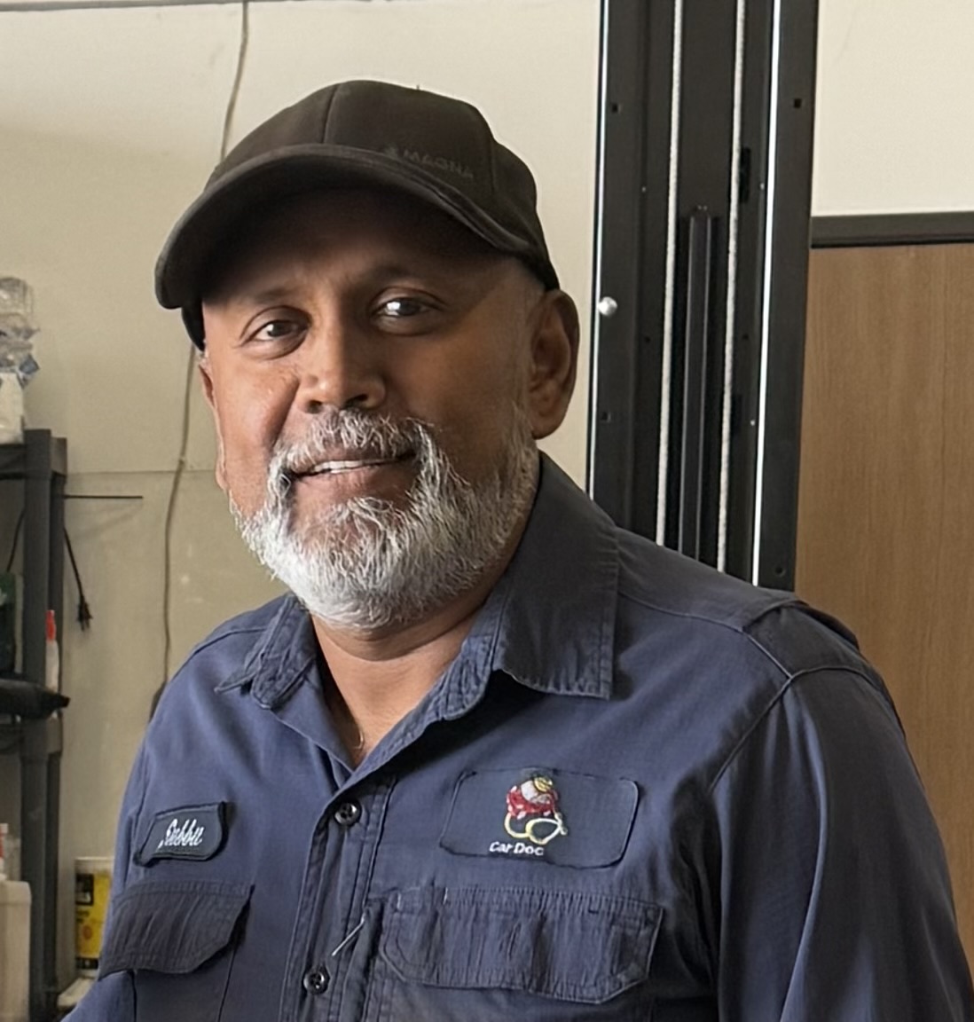Subbu, owner of Car Doc, inside the repair shop